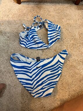 triangl swimwear Blue and White Zebra Stripe Bikini.
L is missing on the logo